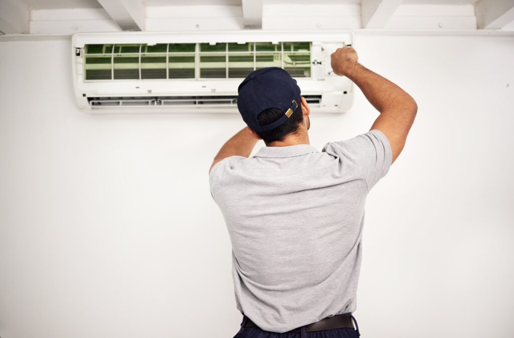 Maintenance, air conditioning technician and man from back working on ventilation filter for ac rep